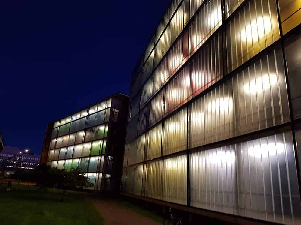 three group of gold coins on top of the newspaper showing statistics on them.